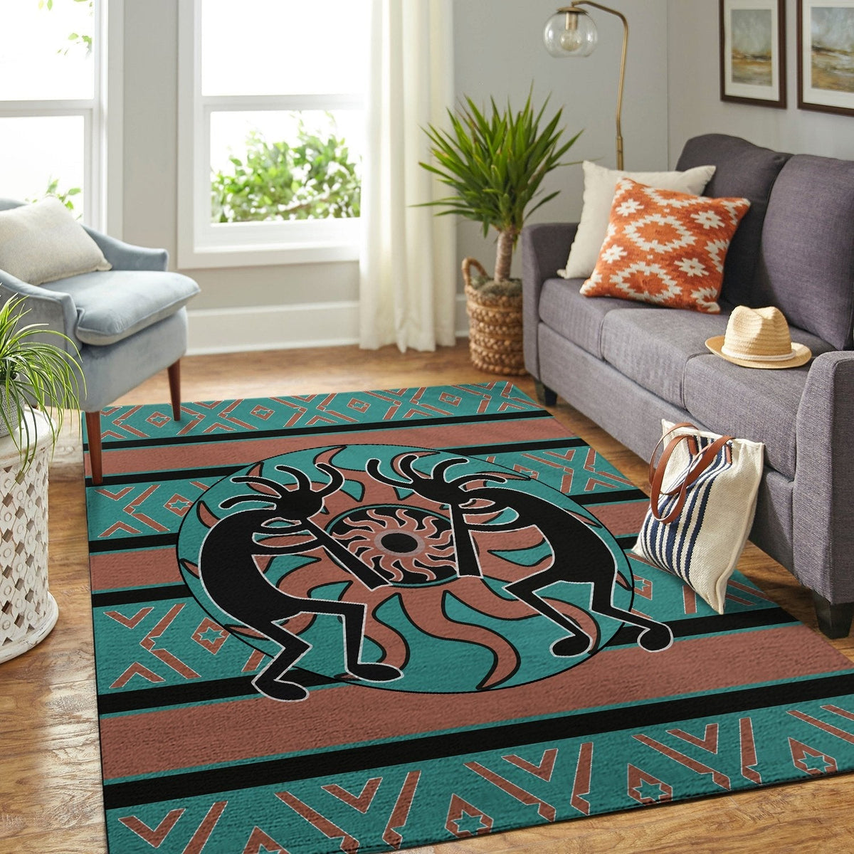 Large Kokopelli area rug with teal field, rust center, black figure, and multicolor border pattern