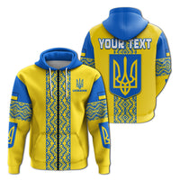 Yellow hoodie, front and back views: trident emblem and blue-white Ukrainian pattern