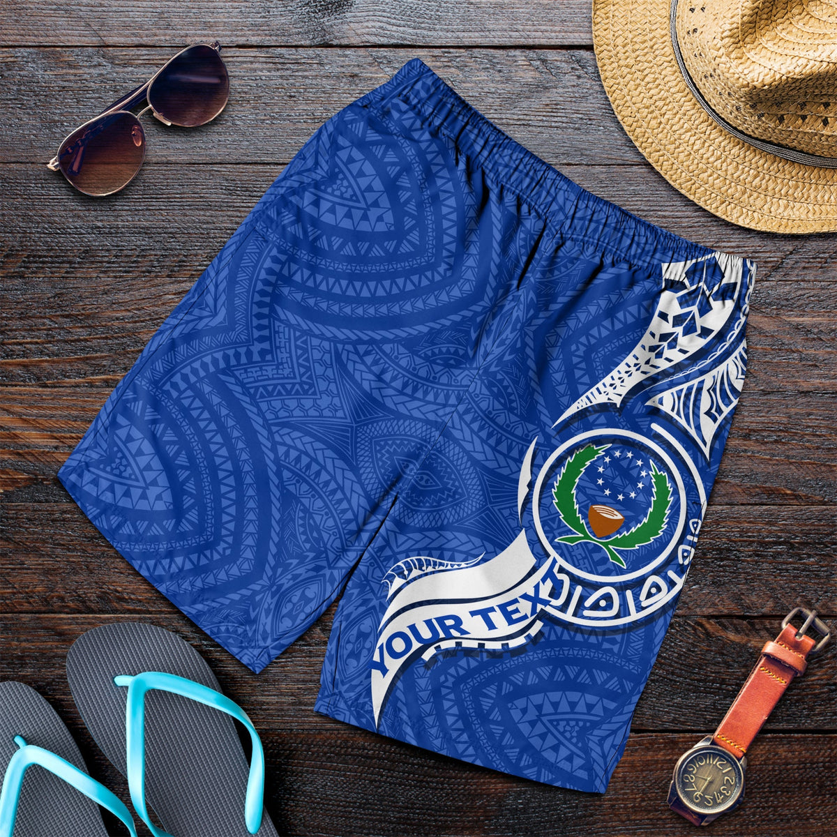 Blue swim shorts folded, tribal print with large emblem on side