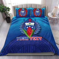 Blue bedding set with crest, laurel, red wreaths, and “YOUR TEXT” on duvet and pillows