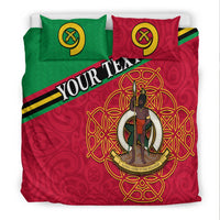 Red duvet cover with “YOUR TEXT” stripe and golden circular emblem; green and red pillows