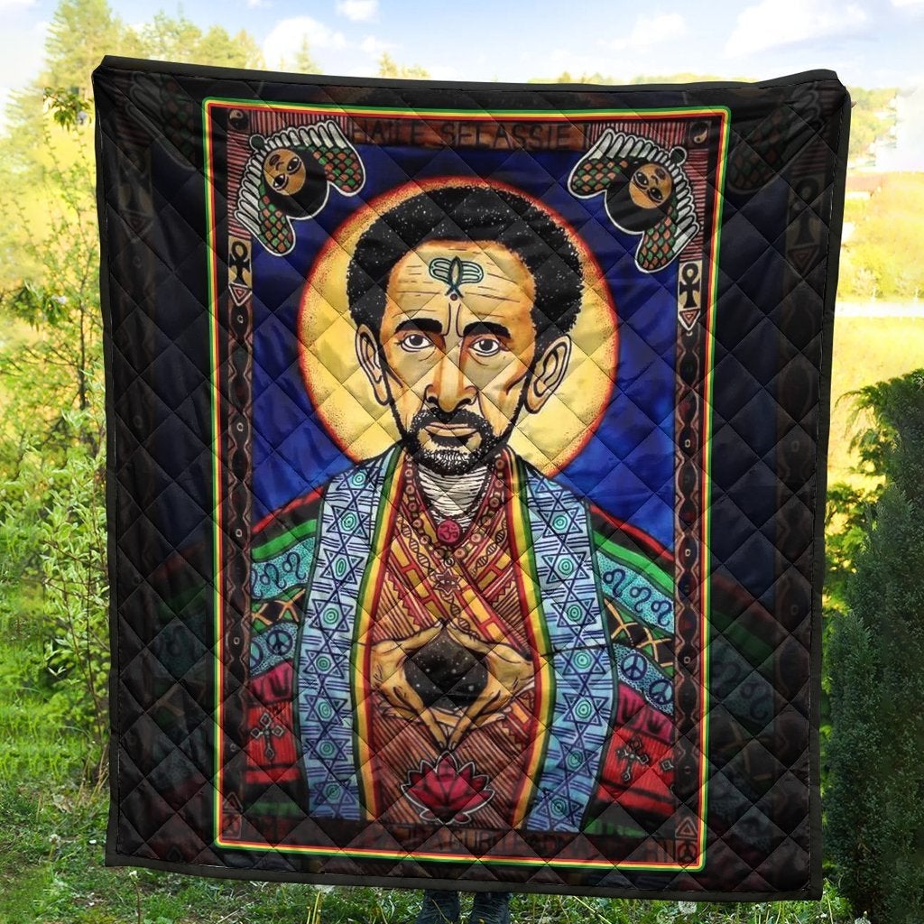 Black quilt with multicolor border, Haile Selassie portrait and cat faces in corners