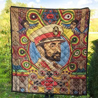 Large multicolor quilt outdoors, central portrait with wings and star motif