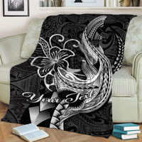 Black Polynesian shark tattoo blanket draped on a couch, white ink tribal design