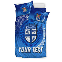 Blue duvet with Fiji crest shield, palm motifs, and 'YOUR TEXT', plus matching pillow set