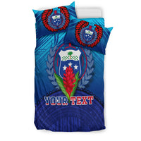 Blue duvet and pillowcases with crest wreath design and bold 'YOUR TEXT' lettering