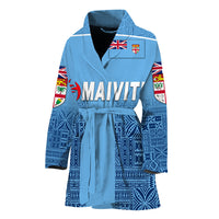Blue rugby bathrobe with patterned sleeves, open collar, belt tie, crest badge on chest