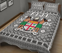 Grey Fiji quilt bed set detail: geometric triangle print with lower border and pillow