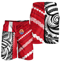 Red swim shorts with white chevrons and black-and-white tribal side panel, elastic waistband