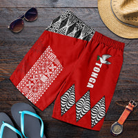 Red rugby shorts with white geometric panel, black-and-white zigzag triangles, and bird logo