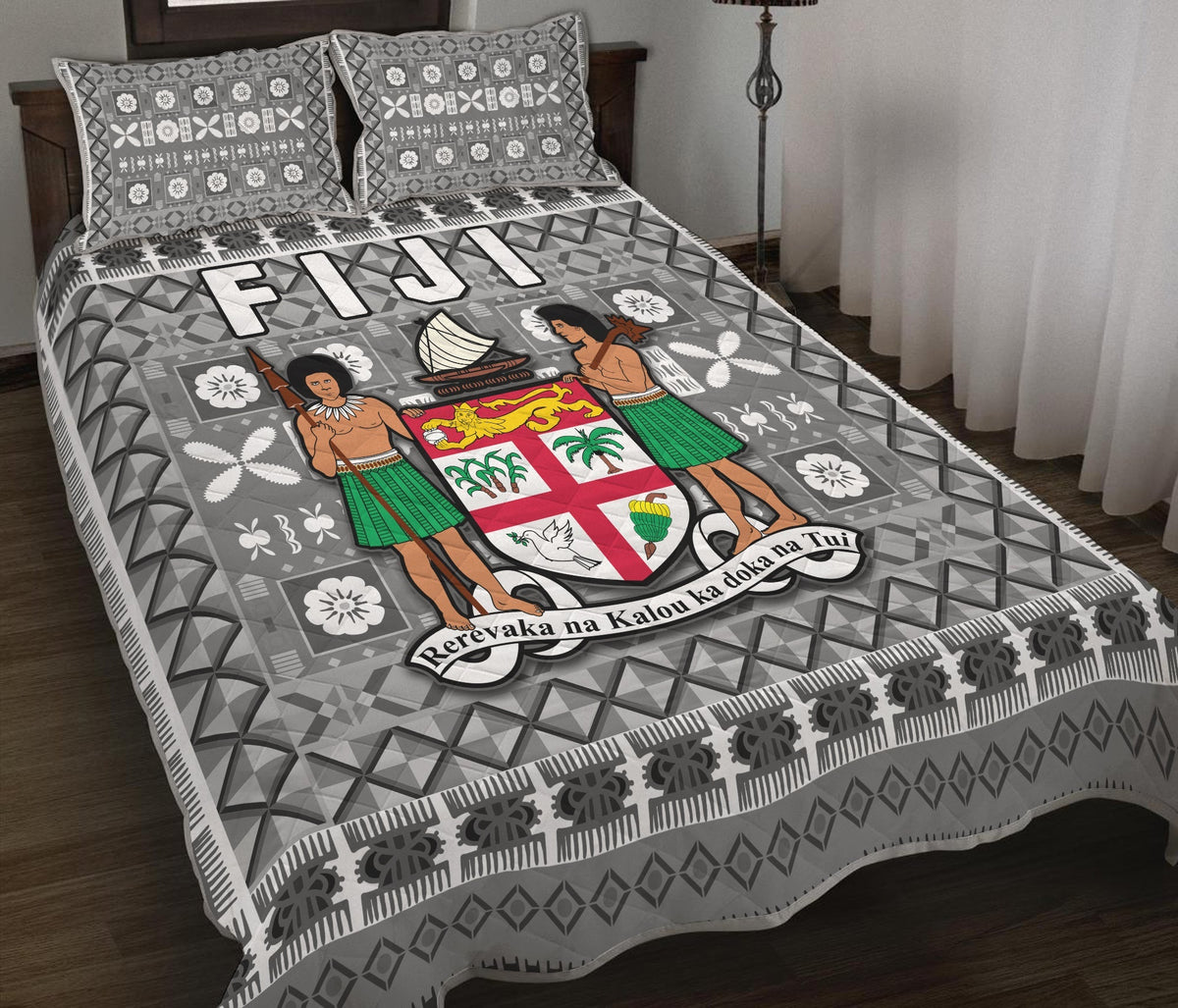 Grey patterned quilt with Fijian tapa figures, geometric triangles, and border stripe