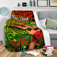 Draped hula girl 'Aloha' blanket over gray sofa with white plush border and floral print