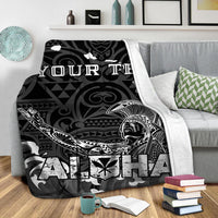 Black Hawaii blanket on sofa with white warrior graphic and ALOHA lettering