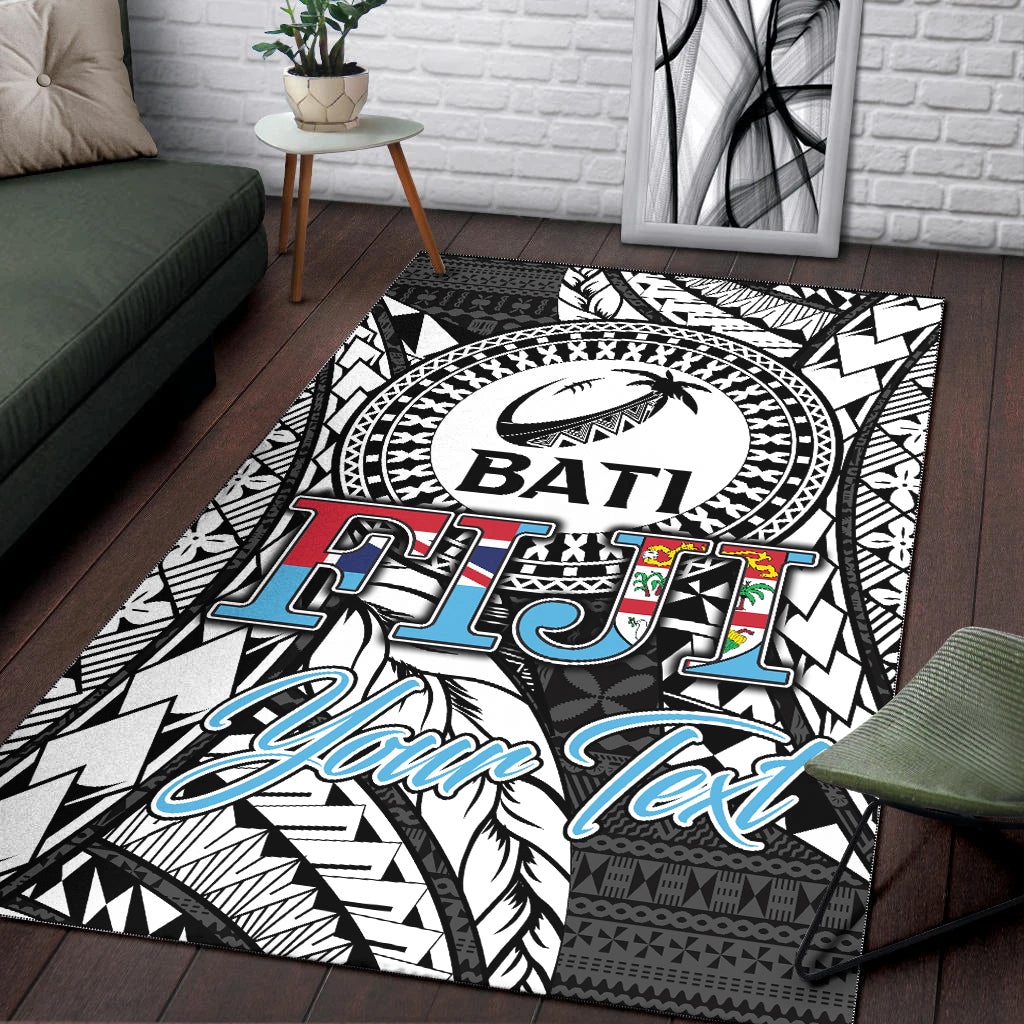 Black Bati tapa area rug with BATI logo, tribal pattern, and blue “Your Text”
