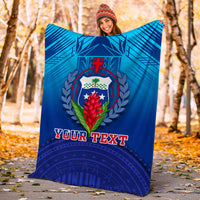 Blue personalized fleece blanket showing crest emblem and “YOUR TEXT” text