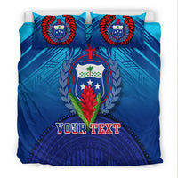 Blue bedding set front view: two pillows, crest medallion, and 'YOUR TEXT' banner