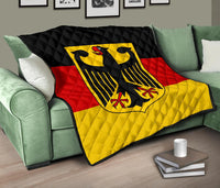 Germany flag quilt on green sofa, black top and red/yellow stripes with eagle shield