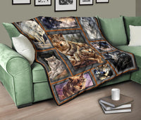 Wolf quilt on green sofa arm, nine-panel framed wolves in muted gray and brown