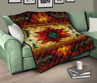 Quilt over green sofa: bold red and gold geometric star with green details and dark edge trim