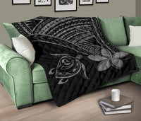 Black quilt with grey turtle face and large plumeria flower, diamond geometric trim