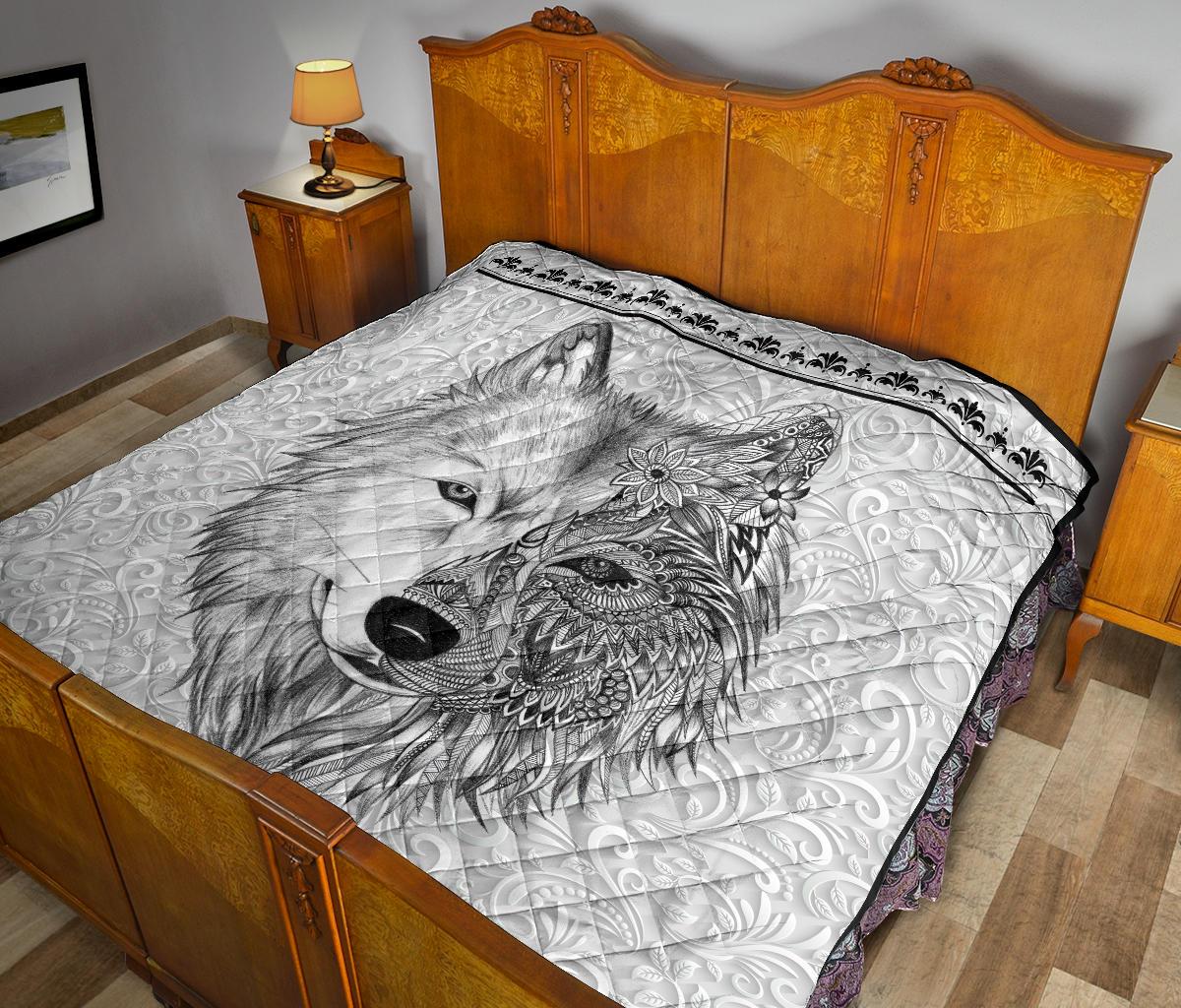 White quilt with black wolf face and floral mandala design, decorative dark border
