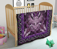 Purple mandala quilt on rail bed, detailed white beadwork pattern with green border