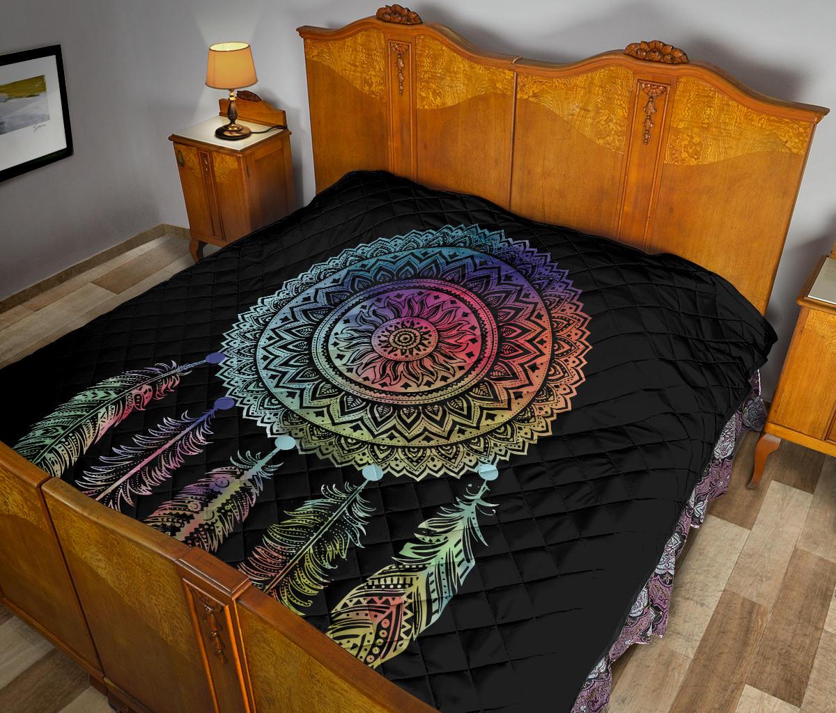 Black quilt featuring a multicolor dreamcatcher mandala center and feather design