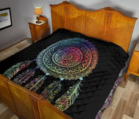 Black quilt featuring a multicolor dreamcatcher mandala center and feather design