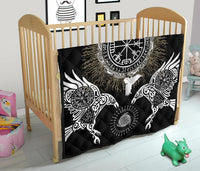 Black quilt with circular Vegvisir, Valknut and raven motifs, laid over crib