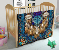 Native-style blue quilt blanket with centered wolf face, feathers, and geometric border