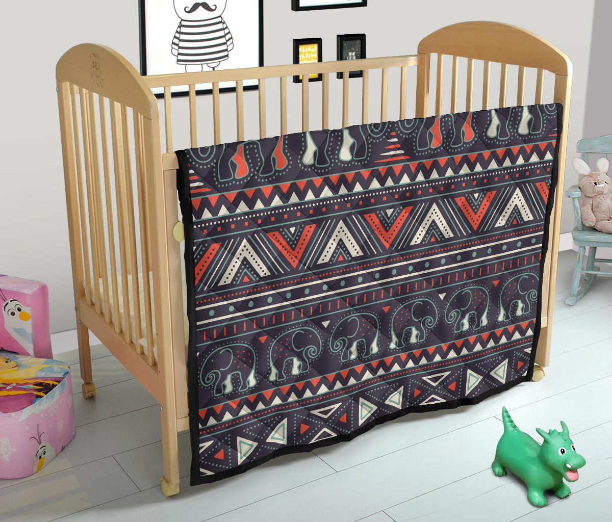 Crib quilt with tribal elephant print, dark geometric bands with red and teal accents