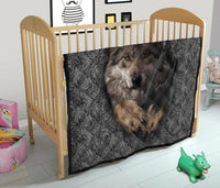 Baby crib quilt with swirling black-and-gray pattern and wolf face center graphic