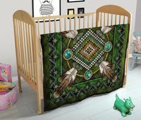 Green quilt featuring mandala design with turquoise oval accents and native-style rays