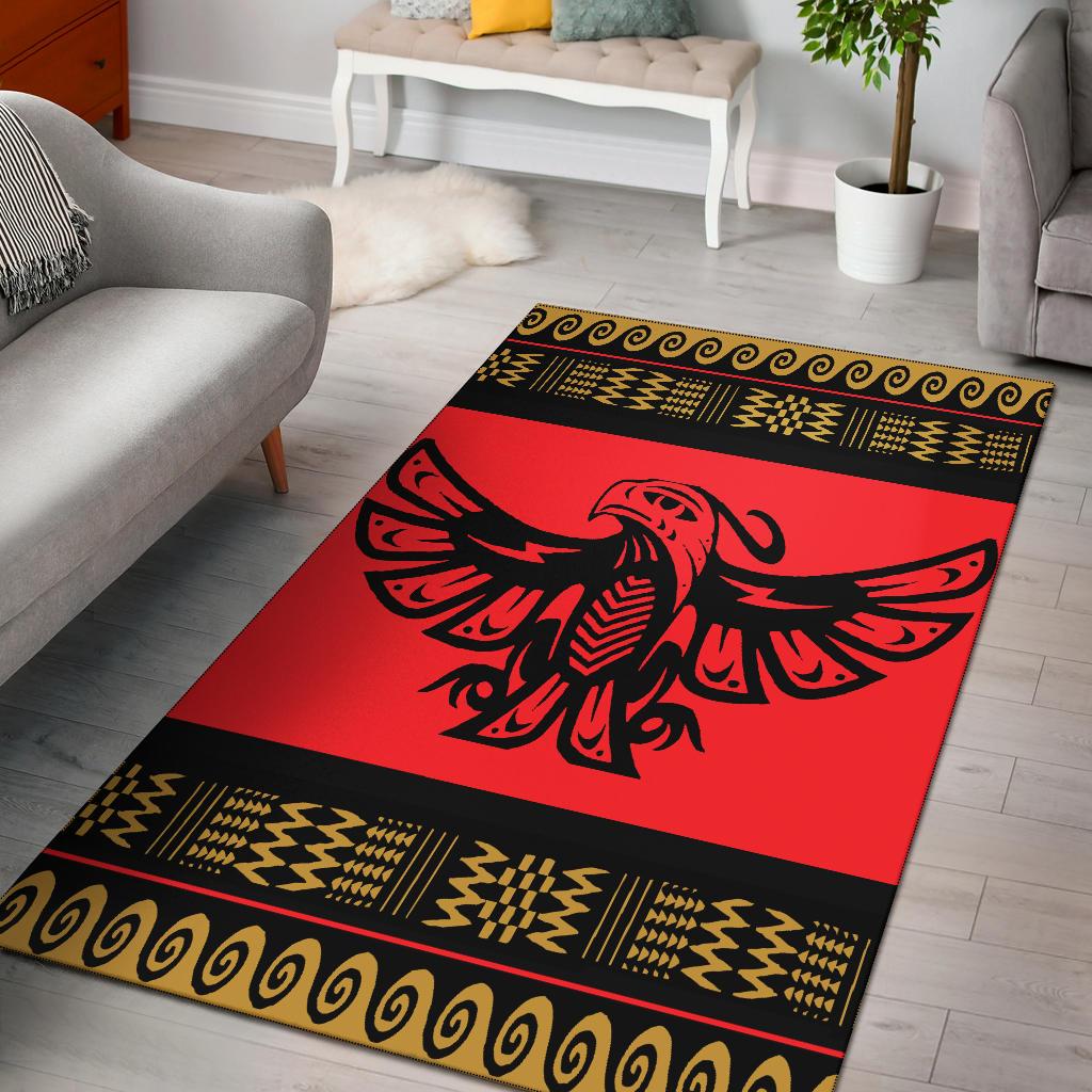 Red area rug with black border and gold Native-style pattern, eagle centerpiece