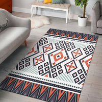 Purple tribal area rug with geometric blocks, diamonds, stripes, and border