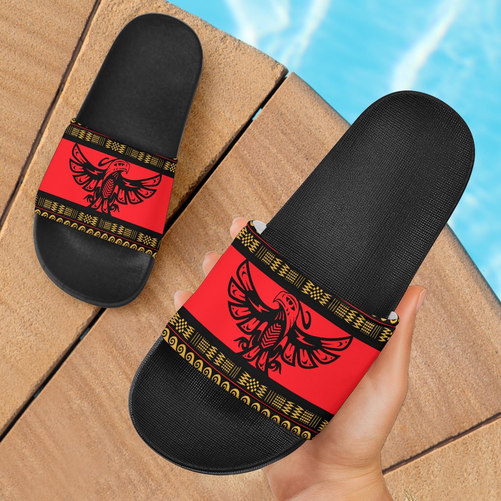 Red Native American pattern slide sandals with black sole and red strap, yellow trim