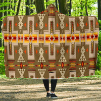 Light brown Native American patterned hooded blanket with multicolor geometric motifs