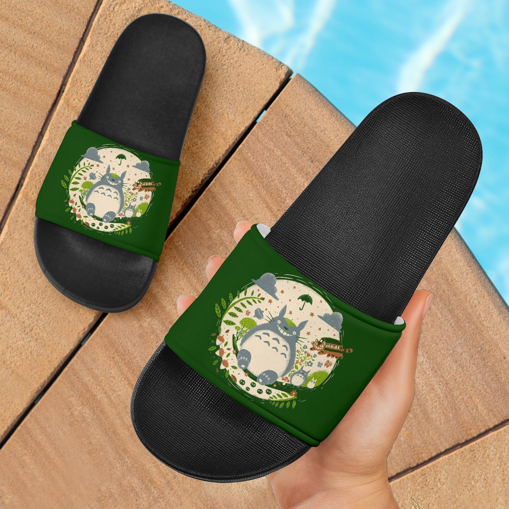 Green slide sandals with black textured footbed and Totoro-themed scene on straps