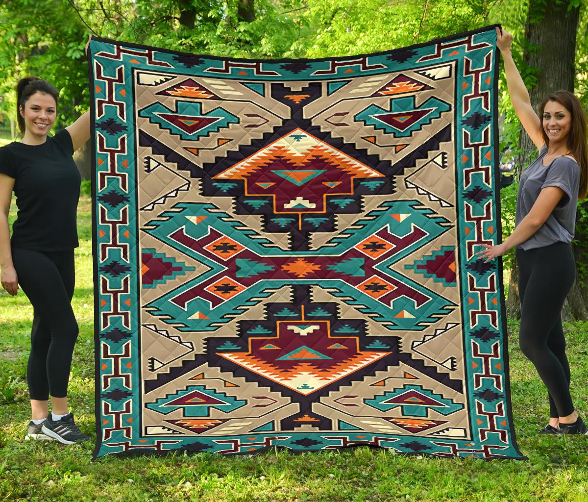 Quilt with multicolor Native-style geometric pattern, teal border and central star motifs