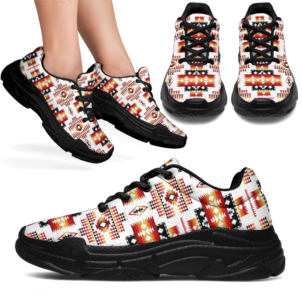 Tribes pattern chunky sneakers, white upper with red/orange/black design, black sole, lace-up