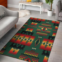 Green native-style area rug with red, yellow, and black geometric blocks