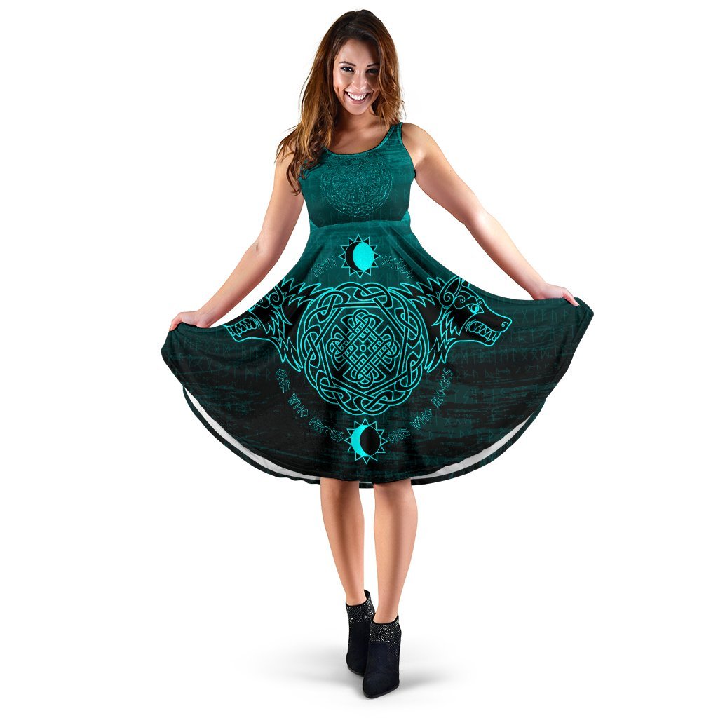 Teal sleeveless dress with dark skirt and teal Norse-style circular pendant print
