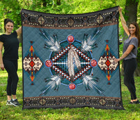 Blue Native American pattern quilt with central dreamcatcher motif and geometric border.