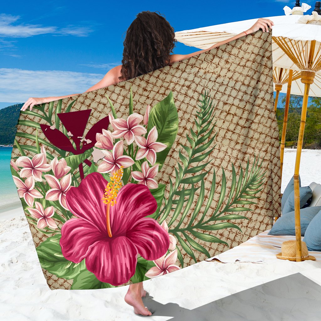 Tan Hawaiian sarong with pink hibiscus, plumeria flowers, and green leaf pattern