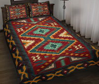 Colorful tribal Native American quilt bed set with red, teal, and geometric diamond patterns