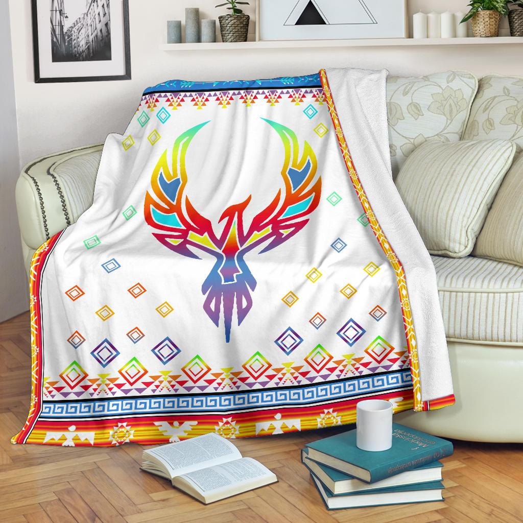 White blanket featuring a multicolor phoenix skull and blue-green diamond motifs