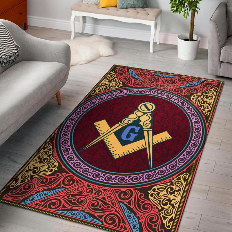 Red rug with circular emblem and ornate gold, blue, and pink border
