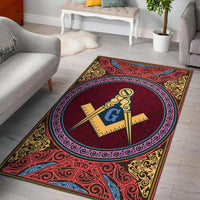Red rug with circular emblem and ornate gold, blue, and pink border