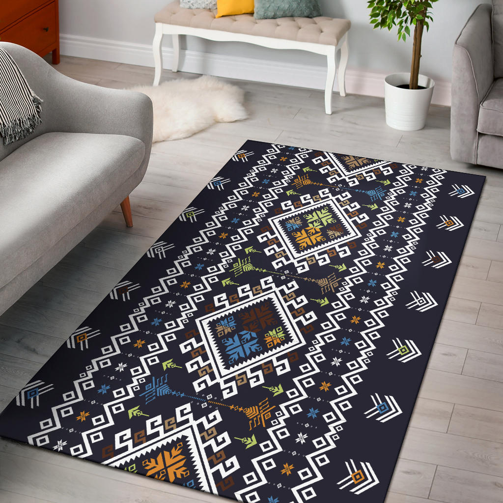 Dark navy area rug with geometric white squares and colorful diamond medallions