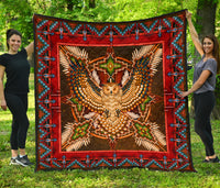Red and multicolor Native-style mandala quilt with central owl figure and border pattern